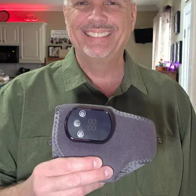 a happy customer holding a foot care massager